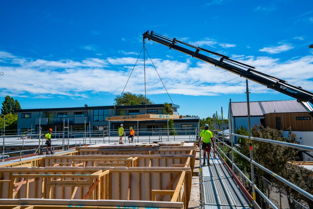 VIP Frames & Trusses timber frames being lowered by crane onsite by VIP Frames & Trusses workers