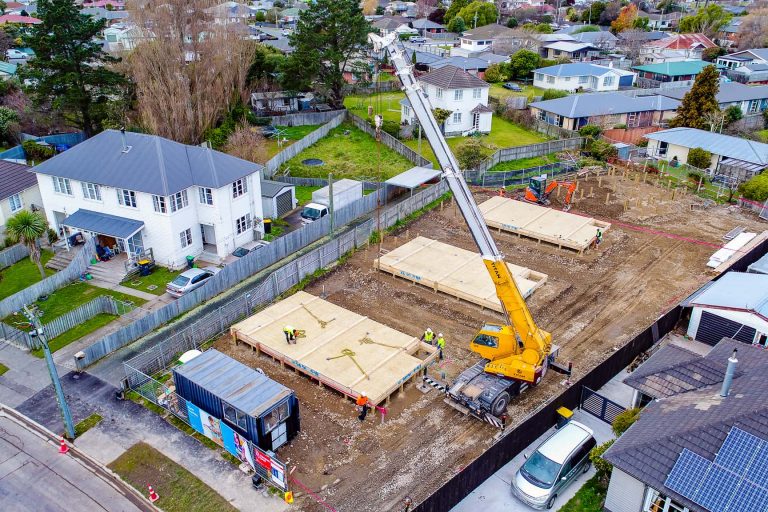 VIP Frames & Trusses timber frames being lowered by crane onsite by VIP Frames & Trusses workers