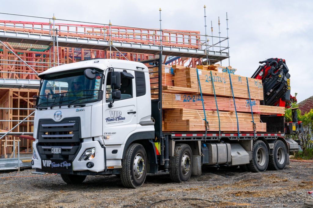 VIP Frames & Trusses crane truck on site loaded with prefab timber framing