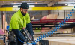 VIP Frames & Trusse staff member in factory using commercial nail gun