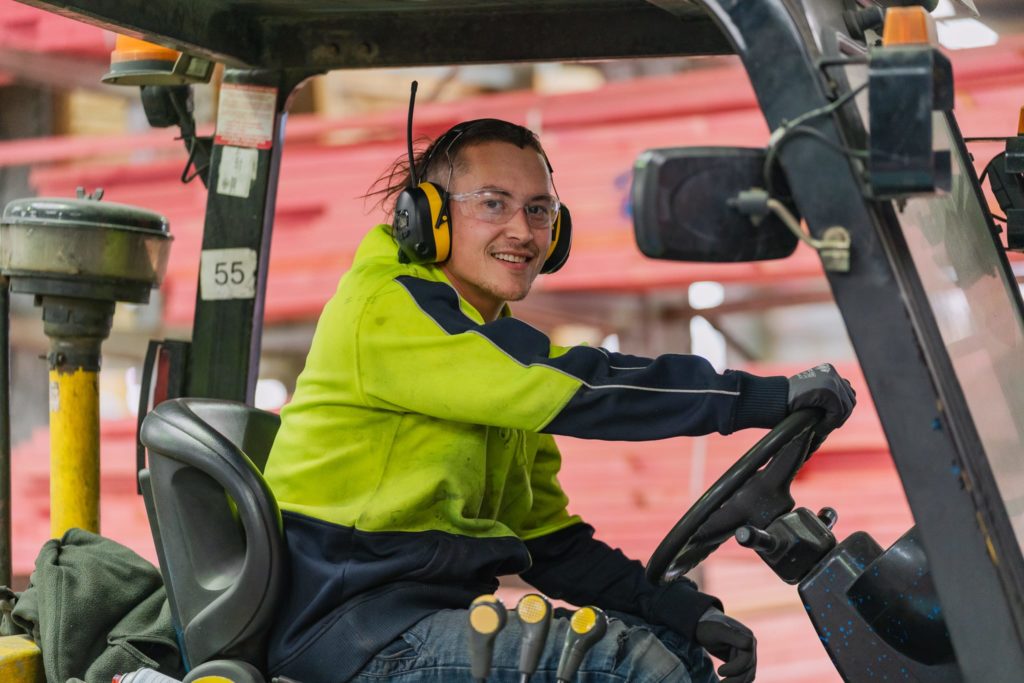 VIP Frames & Trusses staff member driving forklift in factory