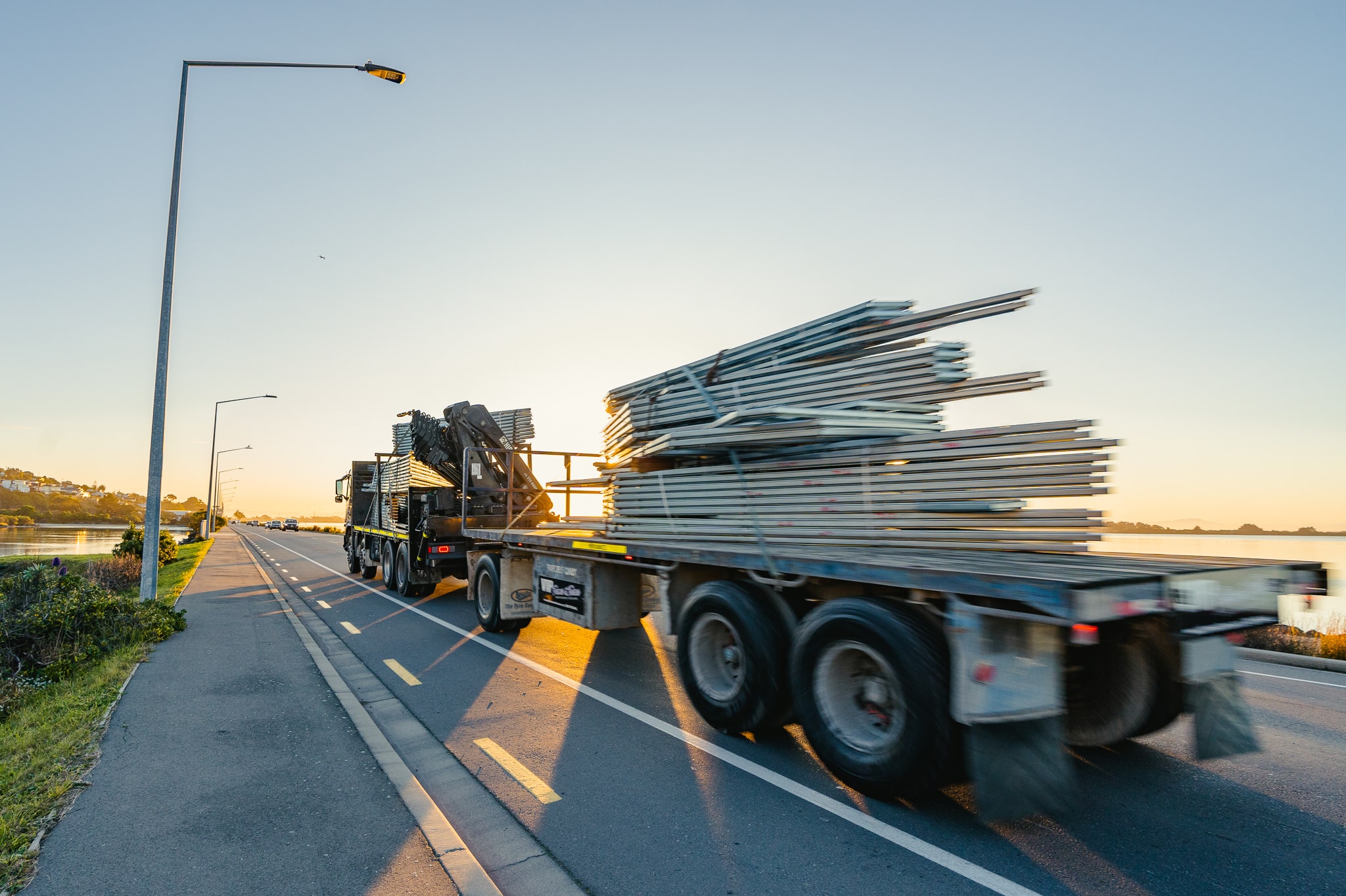 VIP Frames & Trusses truck transporting prefab frames and trusses to site